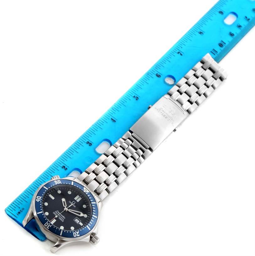 The image shows an Omega Seamaster 2541.80.00 Men
s Stainless Steel Blue Dial 2541.80.00 Men
s Stainless Steel Blue Dial watch laid flat with a blue ruler beside it for scale.