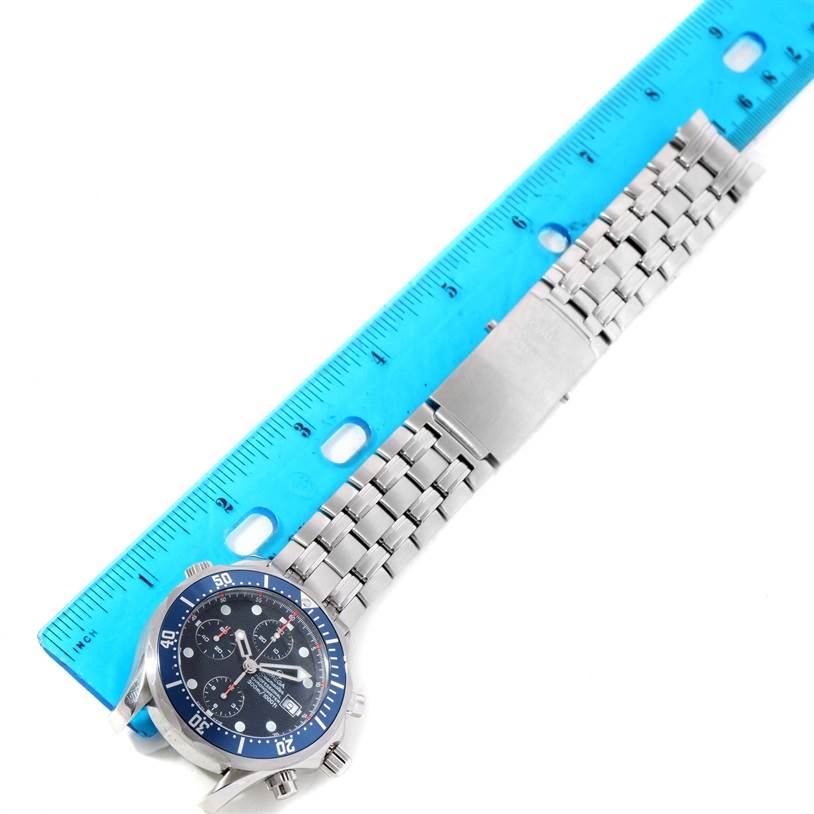 The Omega Seamaster 2599.80.00 Men
s Stainless Steel Blue Dial 2599.80.00 Men
s Stainless Steel Blue Dial watch is shown from an overhead angle, displaying the face, bezel, and part of its metal bracelet with a ruler for scale.