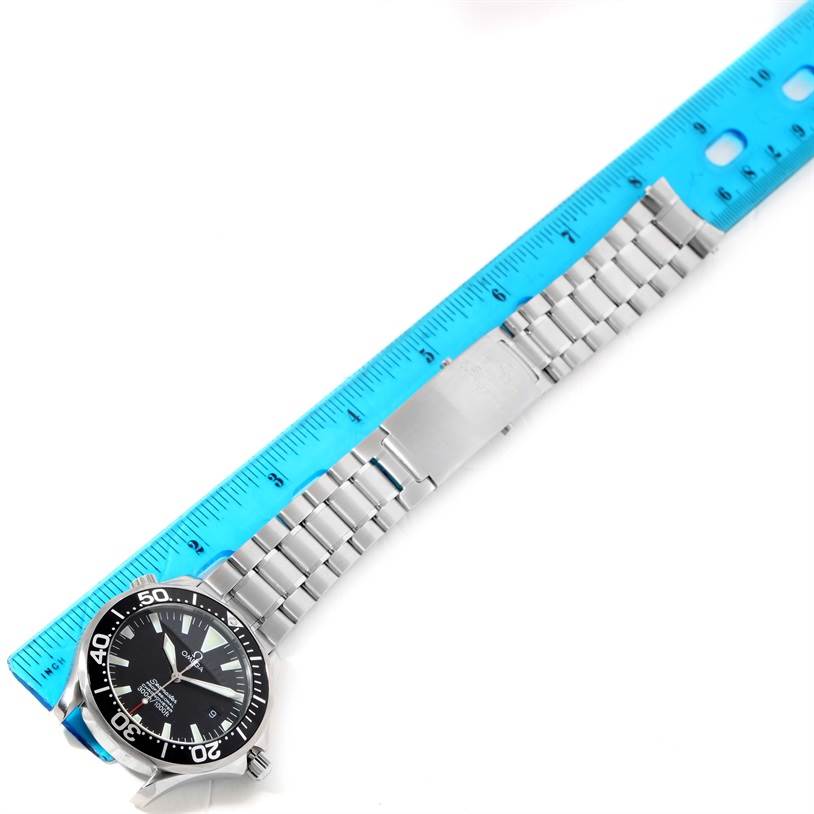 The image shows an Omega Seamaster 2254.50.00 Men
s Stainless Steel Black Dial 2254.50.00 Men
s Stainless Steel Black Dial watch laying flat, with its bracelet extended beside a blue ruler for measurement.