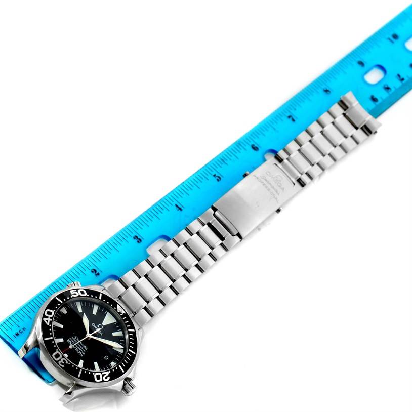 The image shows an Omega Seamaster 2254.50.00 Men
s Stainless Steel Black Dial 2254.50.00 Men
s Stainless Steel Black Dial watch laid flat next to a blue ruler, highlighting the front of the watch and its metal bracelet.