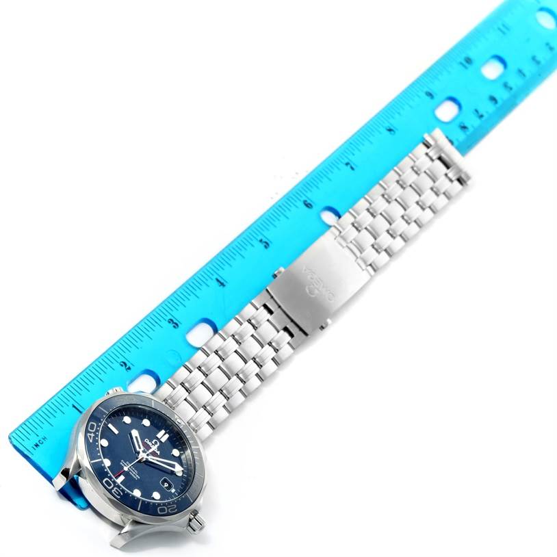 The Omega Seamaster 212.30.41.20.03.001 Men
s Stainless Steel Blue Dial 212.30.41.20.03.001 Men
s Stainless Steel Blue Dial watch is shown from a top-down angle, featuring the face, bezel, and metal bracelet partially measured by a blue ruler.