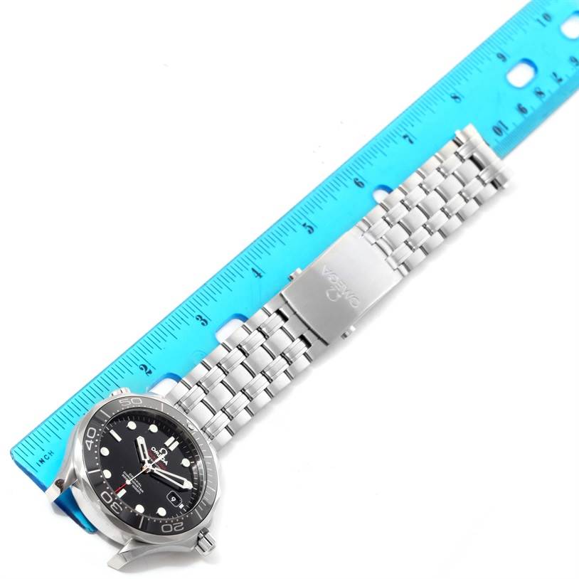 The image shows an Omega Seamaster 212.30.41.20.01.003 Men
s Stainless Steel Black Dial 212.30.41.20.01.003 Men
s Stainless Steel Black Dial watch laid flat, with its stainless steel bracelet extended alongside a blue ruler.