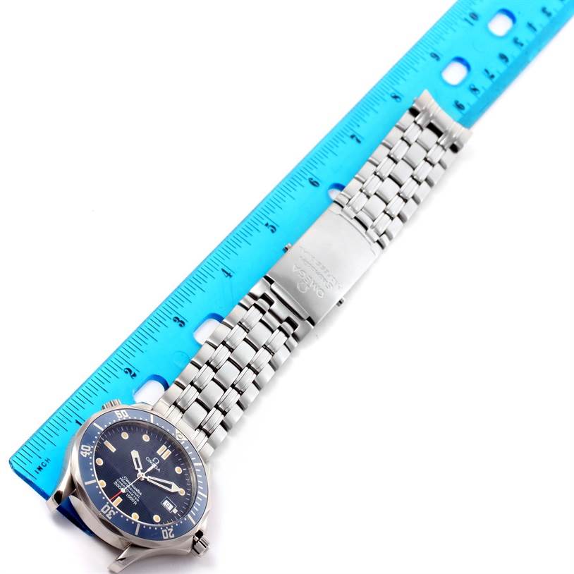 This image shows the Omega Seamaster 2531.80.00 Men
s Stainless Steel Blue Dial 2531.80.00 Men
s Stainless Steel Blue Dial watch laying flat with its face and metal bracelet visible alongside a blue ruler.