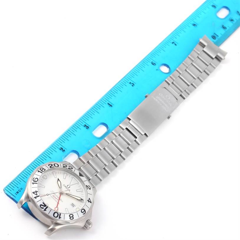 The image shows an Omega Seamaster 2538.20.00 Men
s Stainless Steel White Dial 2538.20.00 Men
s Stainless Steel White Dial watch laid flat, with its metal bracelet aligned with a blue ruler for measurement.