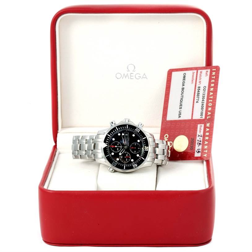 The image shows an Omega Seamaster 213.30.42.40.01.001 Men
s Stainless Steel Black Dial 213.30.42.40.01.001 Men
s Stainless Steel Black Dial watch with a black dial, displayed in a red box alongside its international warranty card.