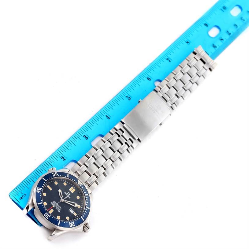 The image shows a top-down view of the Omega Seamaster 2541.80.00 Men
s Stainless Steel Blue Dial 2541.80.00 Men
s Stainless Steel Blue Dial watch, highlighting its face and metal bracelet, with a ruler for scale.