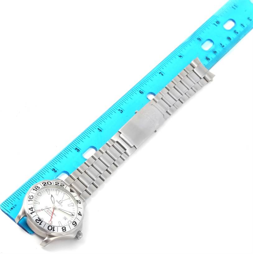 The image shows the Omega Seamaster 2538.20.00 Men
s Stainless Steel White Dial 2538.20.00 Men
s Stainless Steel White Dial watch laid flat against a ruler, displaying its face, bracelet, and clasp.