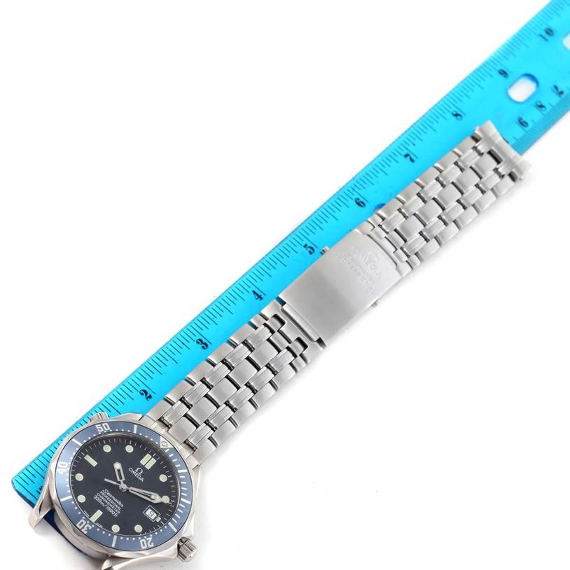 The image shows an Omega Seamaster 2531.80.00 Men
s Stainless Steel Blue Dial 2531.80.00 Men
s Stainless Steel Blue Dial watch lying flat, with its face, stainless steel bracelet, and a measuring ruler visible.