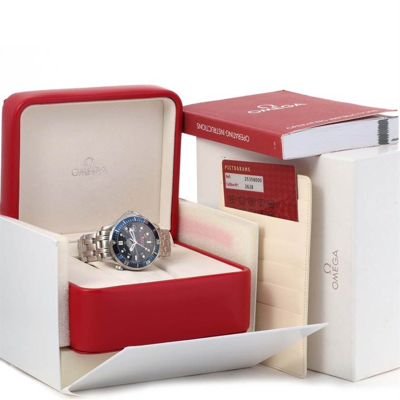 The Omega Seamaster 2535.80.00 Men
s Blue Dial 2535.80.00 Men
s Blue Dial watch is shown in its open box, accompanied by a manual and a cardholder with cards.