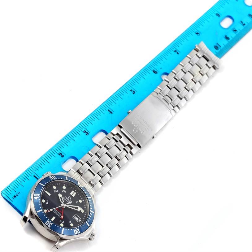 The image shows an Omega Seamaster 2535.80.00 Men
s Blue Dial 2535.80.00 Men
s Blue Dial watch laying flat with its face, bracelet, and clasp visible, measured against a blue ruler.