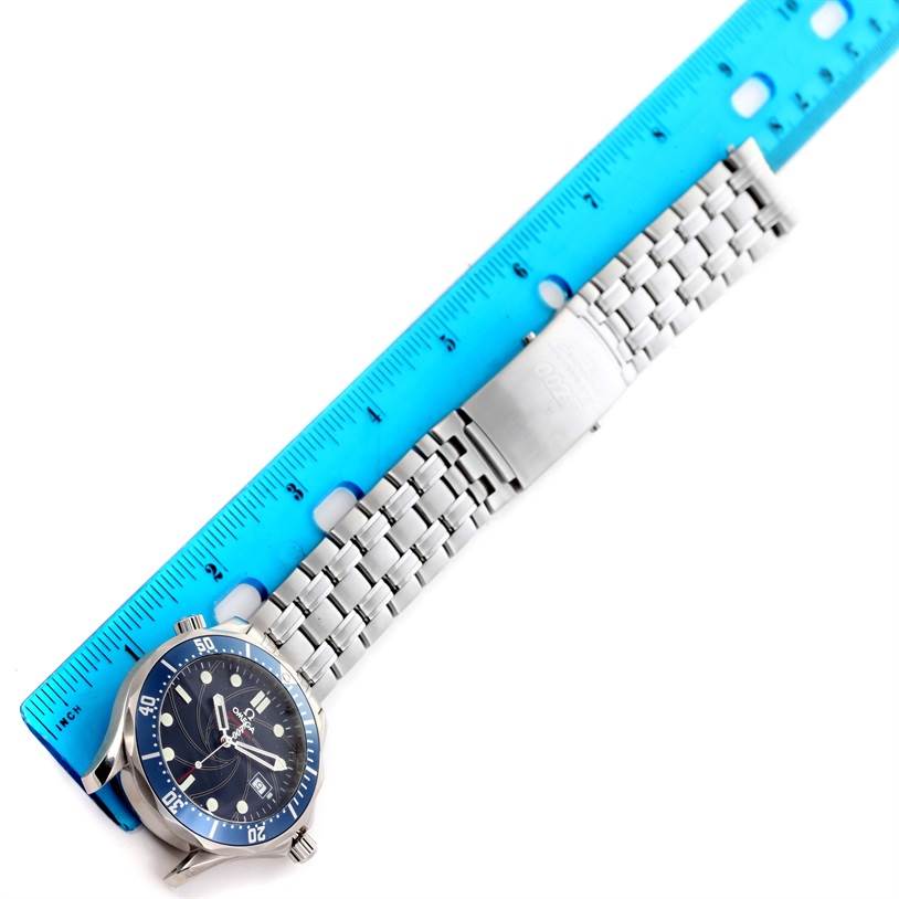 The image shows an Omega Seamaster 2226.80.00 Men
s Stainless Steel Blue Dial 2226.80.00 Men
s Stainless Steel Blue Dial watch with a blue dial and metal bracelet, placed alongside a blue ruler for size reference.