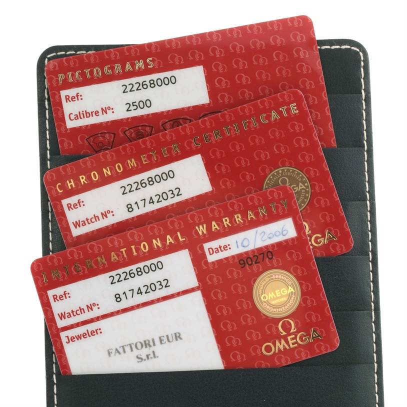 The image shows three red Omega cards for a Seamaster model in a black leather holder, including warranty and certification details.