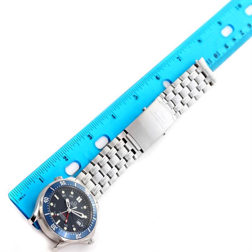 The image shows an Omega Seamaster 2535.80.00 Men
s Stainless Steel Blue Dial 2535.80.00 Men
s Stainless Steel Blue Dial watch laid flat with a ruler measuring its bracelet.