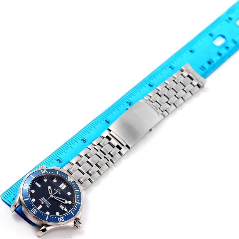 The image shows an Omega Seamaster 2541.80.00 Men
s Stainless Steel Blue Dial 2541.80.00 Men
s Stainless Steel Blue Dial watch lying flat with its face and full bracelet visible alongside a blue ruler for scale.