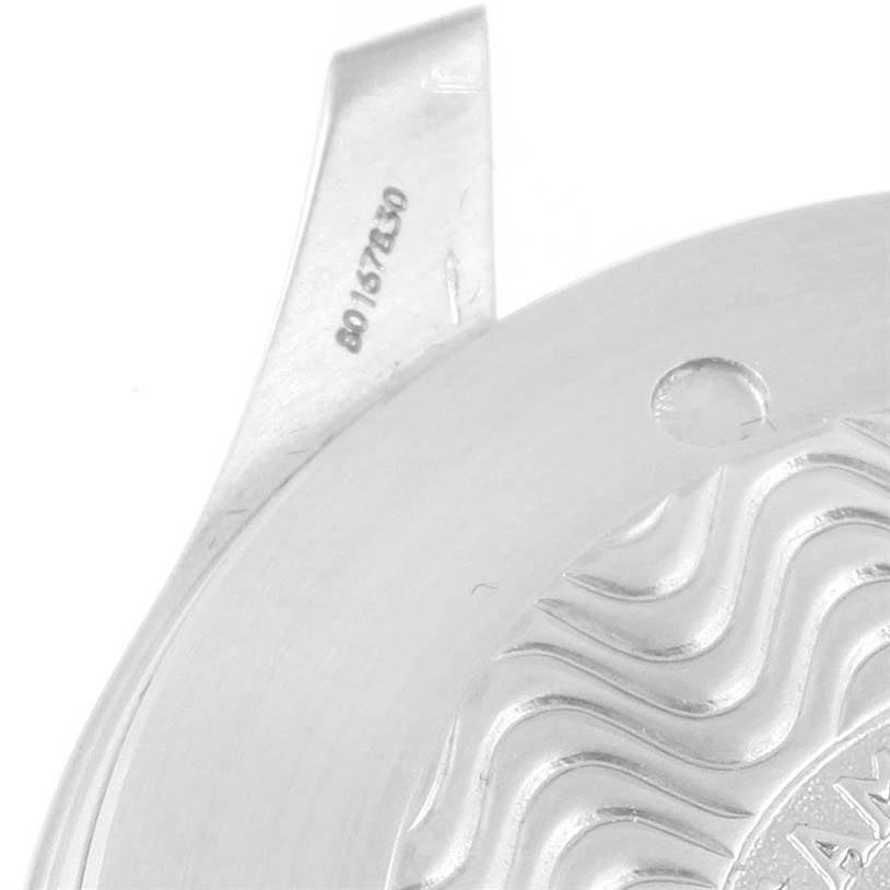 This image shows a close-up of the case back removed from an Omega Seamaster 2538.20.00 Men's Stainless Steel White Dial 2538.20.00 Men's Stainless Steel White Dial watch, highlighting the serial number and part of the wave pattern design.
