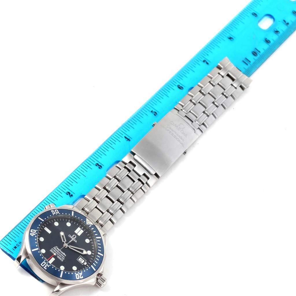 The image shows an Omega Seamaster 2531.80.00 Men
s Stainless Steel Blue Dial 2531.80.00 Men
s Stainless Steel Blue Dial watch laid flat with a blue ruler measuring its length, displaying the face, bezel, and metal bracelet.