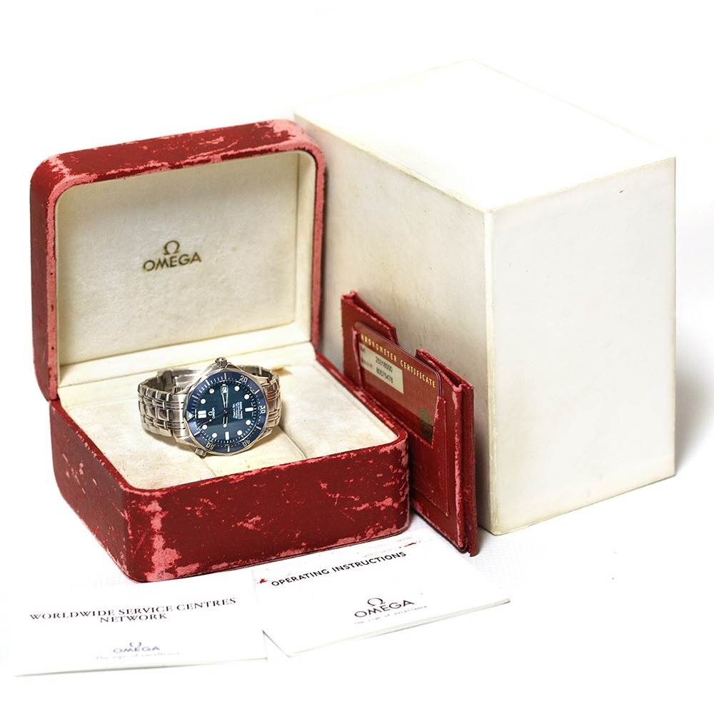 The Omega Seamaster 2531.80.00 Men
s Stainless Steel Blue Dial 2531.80.00 Men
s Stainless Steel Blue Dial watch is displayed in an open red box with certificates and manuals beside it.