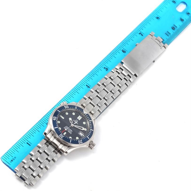 The image shows the Omega Seamaster 2561.80.00 Men
s Stainless Steel Blue Dial 2561.80.00 Men
s Stainless Steel Blue Dial watch laid flat, alongside a ruler, highlighting the watch
s case, dial, bezel, and bracelet.