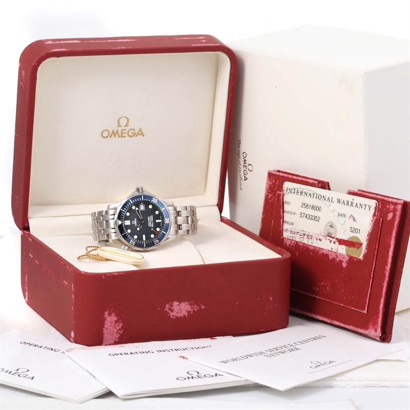This image shows the Omega Seamaster 2561.80.00 Men
s Stainless Steel Blue Dial 2561.80.00 Men
s Stainless Steel Blue Dial watch at an angle in its open box, including warranty cards and operating instructions.