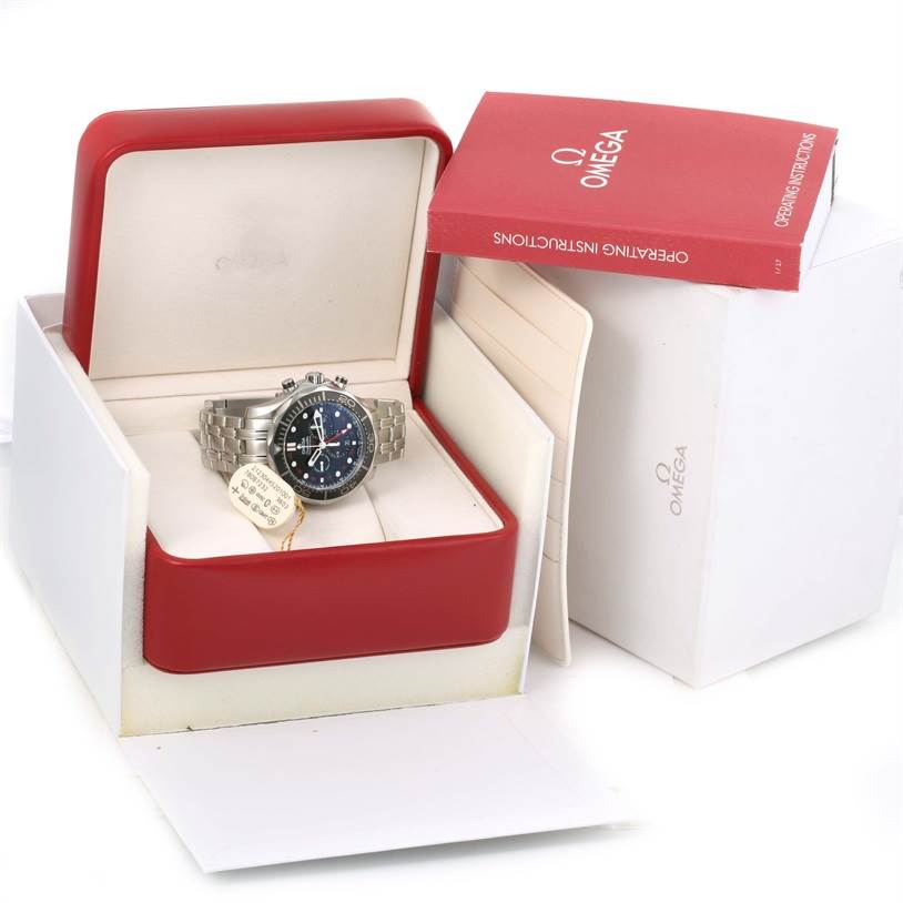 The image shows an Omega Seamaster 212.30.44.52.01.001 Men
s Stainless Steel Black Dial 212.30.44.52.01.001 Men
s Stainless Steel Black Dial watch in its red box with operating instructions outside the box.