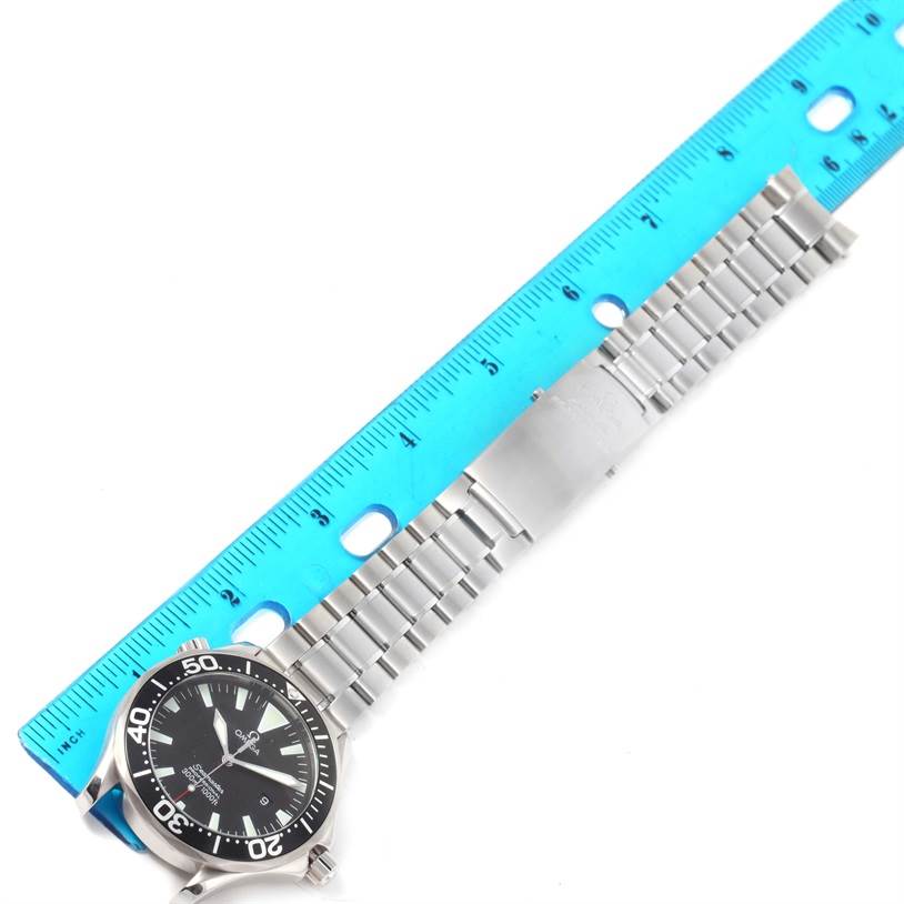 The image shows the Omega Seamaster 2264.50.00 Men
s Stainless Steel Black Dial 2264.50.00 Men
s Stainless Steel Black Dial watch laid flat with a blue ruler measuring its metal bracelet.