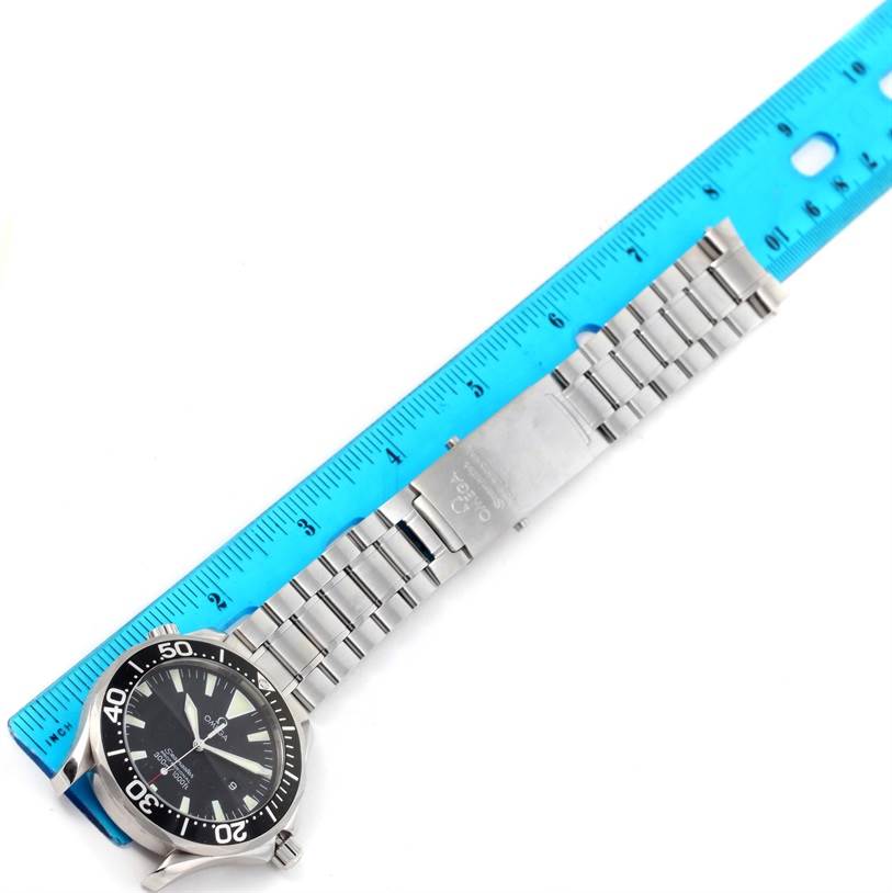 The image shows an Omega Seamaster 2264.50.00 Men
s Stainless Steel Black Dial 2264.50.00 Men
s Stainless Steel Black Dial watch with its metallic strap and clasps laid next to a ruler for measurement.