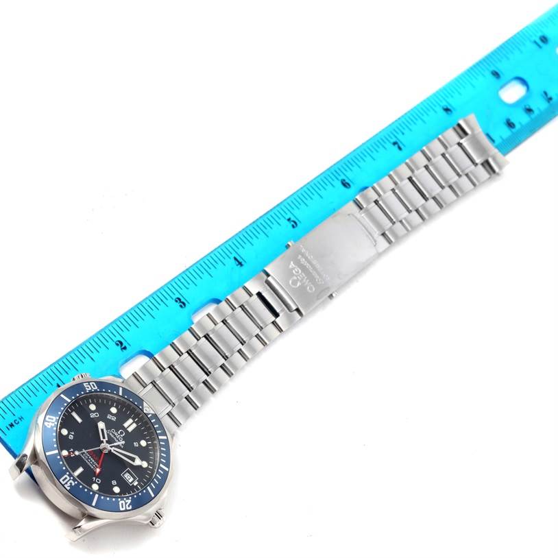 The image shows an Omega Seamaster 2535.80.00 Men
s Stainless Steel Blue Dial 2535.80.00 Men
s Stainless Steel Blue Dial watch laid flat with its metal bracelet fully extended and a ruler next to it for scale.