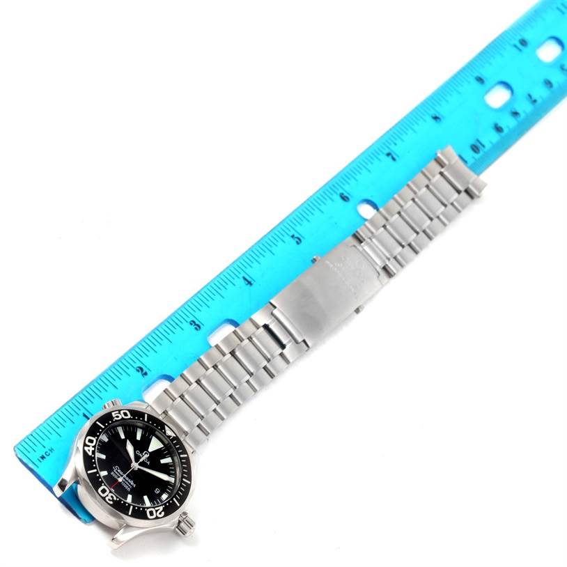 The image shows the Omega Seamaster 2262.50.00 Men
s Stainless Steel Black Dial 2262.50.00 Men
s Stainless Steel Black Dial watch in full length, with its face, bezel, bracelet, and clasp along a blue ruler for size reference.