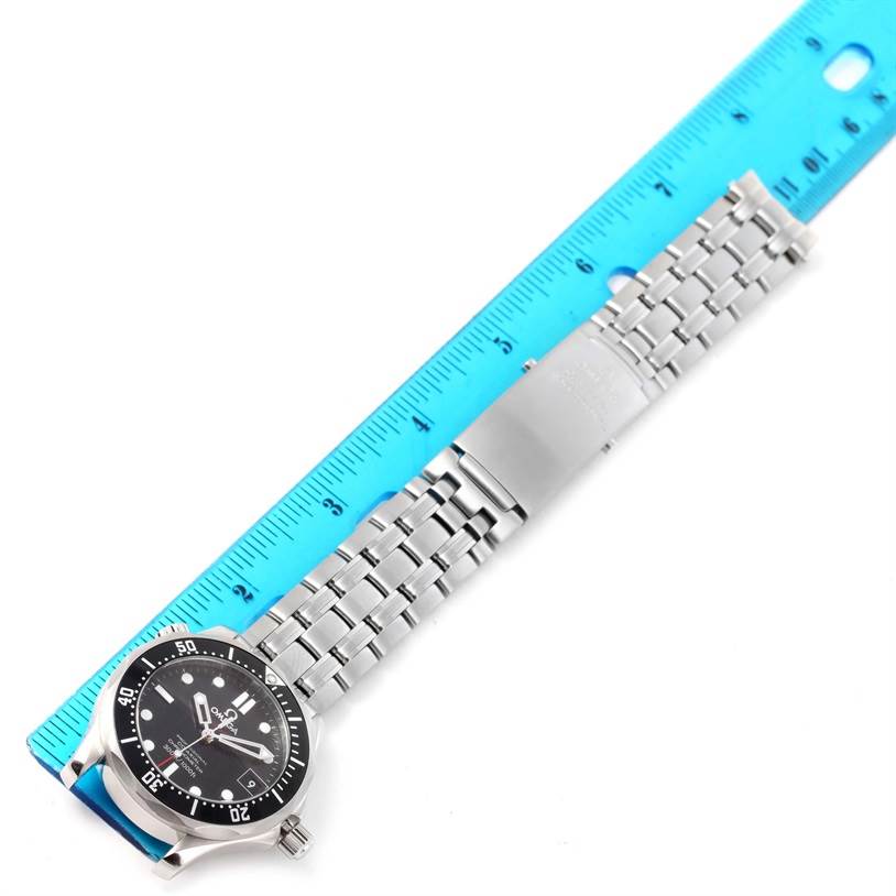 This image shows the front of an Omega Seamaster 212.30.36.20.01.001 Men
s Stainless Steel Black Dial 212.30.36.20.01.001 Men
s Stainless Steel Black Dial watch and its stainless steel bracelet placed next to a ruler.