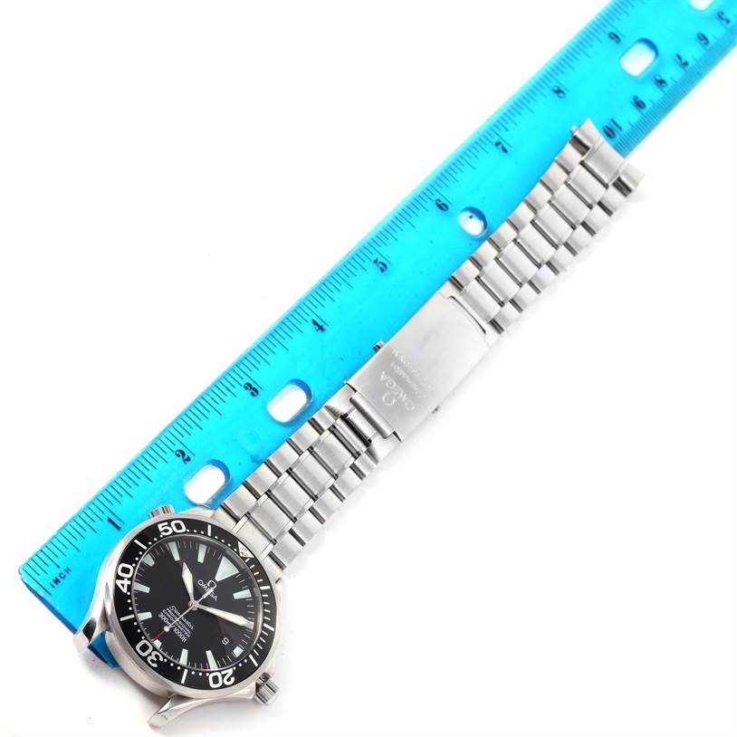 The image shows an Omega Seamaster 2254.50.00 Men
s Stainless Steel Black Dial 2254.50.00 Men
s Stainless Steel Black Dial watch laid flat with its stainless steel bracelet, next to a blue ruler for scale.