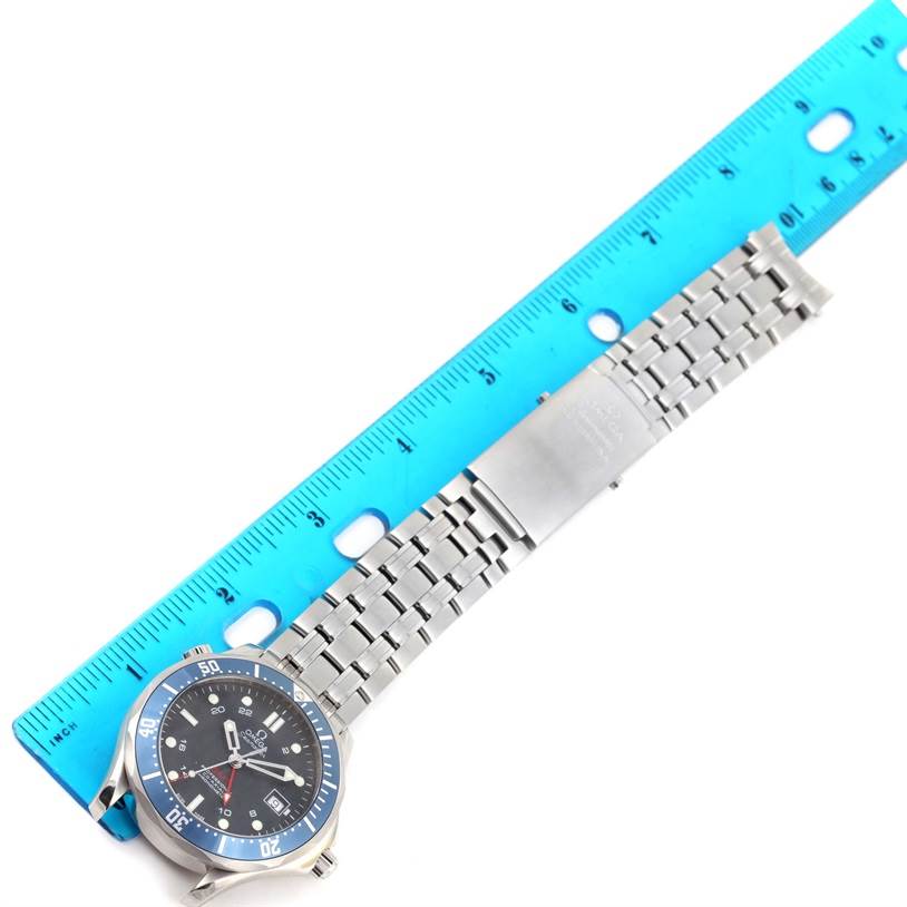 The image shows an Omega Seamaster 2535.80.00 Men
s Stainless Steel Blue Dial 2535.80.00 Men
s Stainless Steel Blue Dial watch with a metal bracelet, positioned next to a blue ruler for scale.