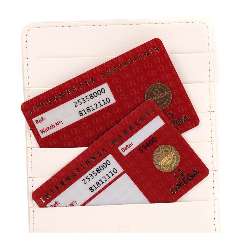 The image shows the International Warranty and Chronometer Certificate cards for an Omega Seamaster 2535.80.00 Men
s Stainless Steel Blue Dial 2535.80.00 Men
s Stainless Steel Blue Dial watch.