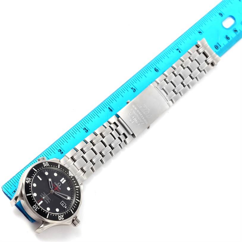 The image shows a top-down view of an Omega Seamaster 212.30.41.20.01.001 Men
s Stainless Steel Black Dial 212.30.41.20.01.001 Men
s Stainless Steel Black Dial watch with its stainless steel bracelet and clasp alongside a ruler for scale.