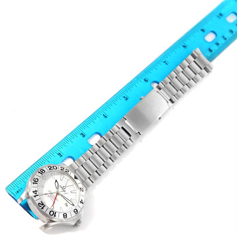 The image shows a top-down view of an Omega Seamaster 2538.20.00 Men's Stainless Steel White Dial 2538.20.00 Men's Stainless Steel White Dial watch with its bracelet aligned next to a blue ruler.