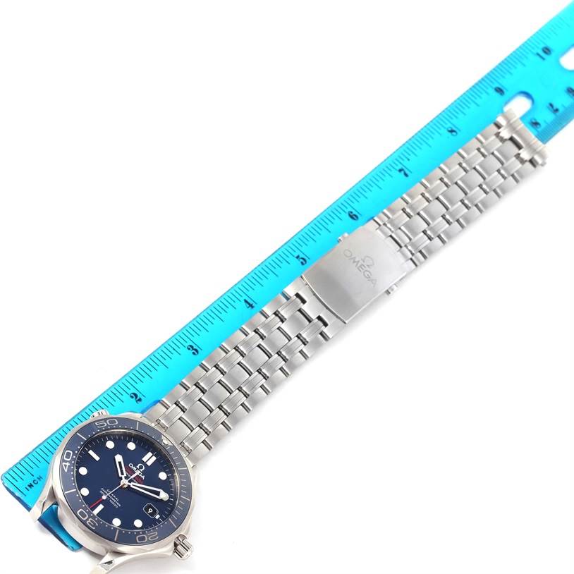 The image shows an Omega Seamaster 212.30.41.20.03.001 Men
s Stainless Steel Blue Dial 212.30.41.20.03.001 Men
s Stainless Steel Blue Dial watch laid flat with its silver bracelet and clasp, alongside a blue ruler measuring its length.