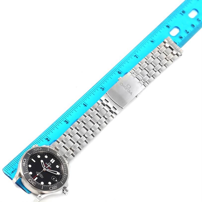 The image shows a top view of the Omega Seamaster 212.30.41.20.01.003 Men
s Stainless Steel Black Dial 212.30.41.20.01.003 Men
s Stainless Steel Black Dial watch, displaying its black face and stainless steel bracelet next to a blue ruler.