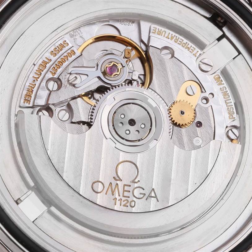 The image shows a close-up view of the interior mechanics and movement of an Omega Seamaster 2537.80.00 Men
s Stainless Steel Blue Dial 2537.80.00 Men
s Stainless Steel Blue Dial watch, including gears and balance wheel.