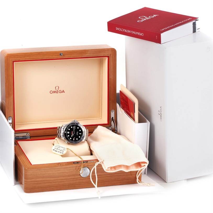 The Omega Seamaster 212.30.41.20.01.003 Men
s Stainless Steel Black Dial 212.30.41.20.01.003 Men
s Stainless Steel Black Dial watch is shown from the front inside an open wooden box, accompanied by a manual, cards, and a pouch.