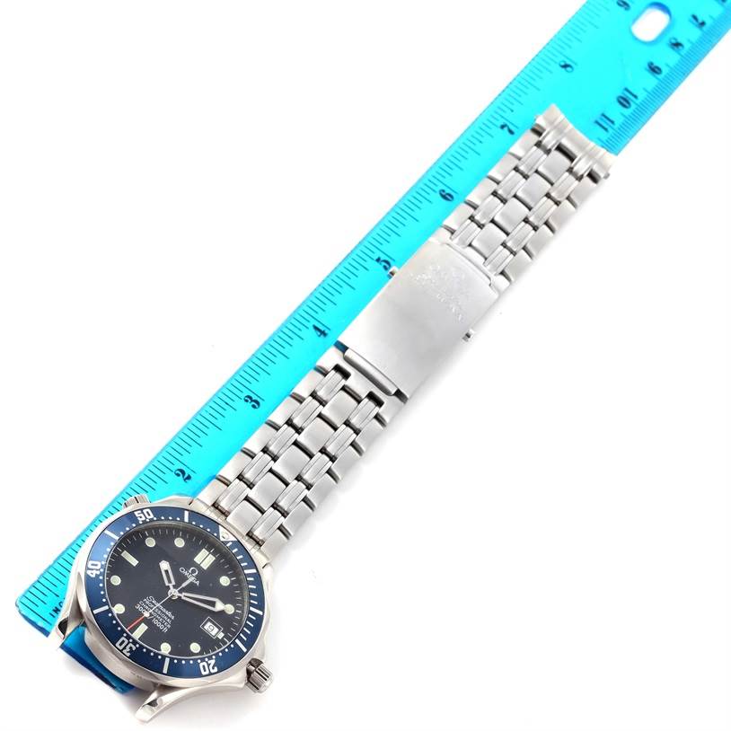 The Omega Seamaster 2531.80.00 Men
s Stainless Steel Blue Dial 2531.80.00 Men
s Stainless Steel Blue Dial watch is shown at an angled overhead view displaying the dial, bracelet, and clasp, alongside a blue ruler for scale.