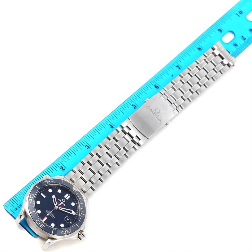 The image shows an Omega Seamaster 212.30.41.20.03.001 Men
s Stainless Steel Blue Dial 212.30.41.20.03.001 Men
s Stainless Steel Blue Dial watch laid flat next to a blue ruler, highlighting its metal bracelet and clasp.