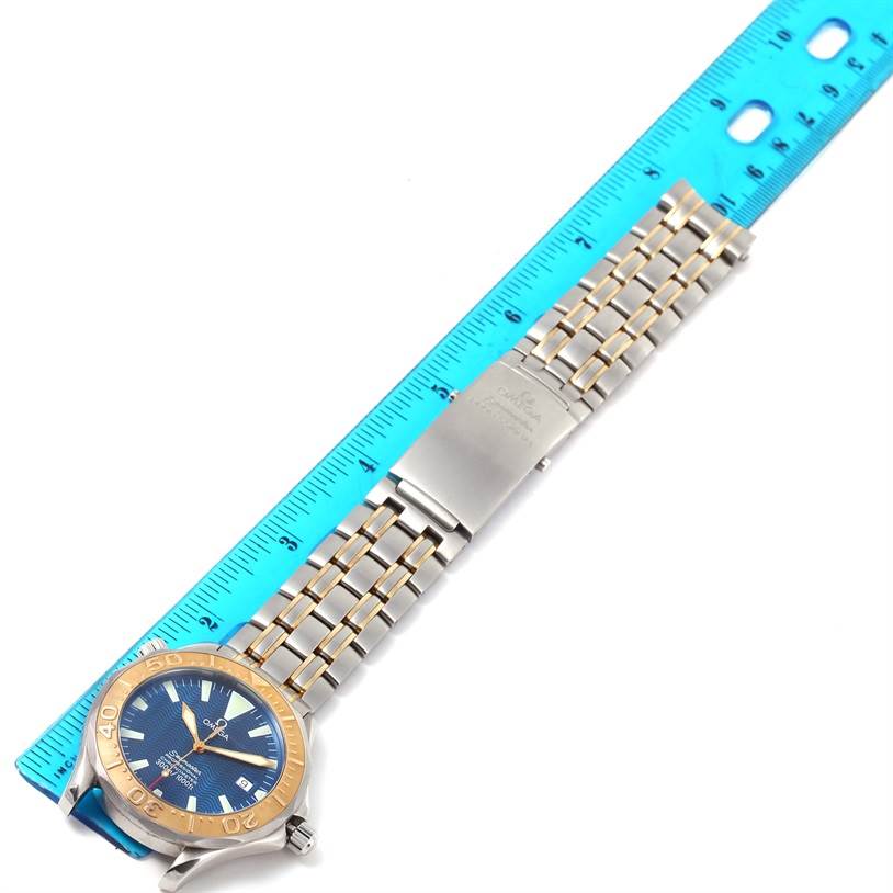 The Omega Seamaster 2455.80.00 Men
s Stainless Steel Blue Dial 2455.80.00 Men
s Stainless Steel Blue Dial watch is shown from a top angle, displaying the face, bezel, and metal bracelet with a ruler.