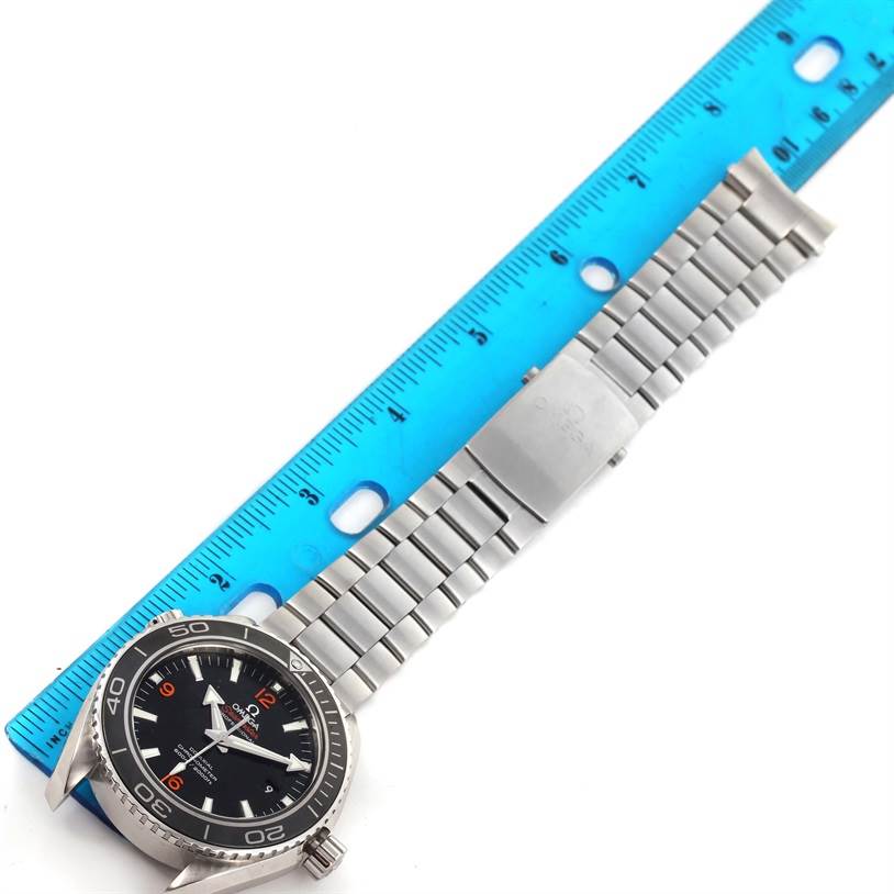 The image shows an Omega Seamaster 232.30.42.21.01.003 Men
s Stainless Steel Black Dial 232.30.42.21.01.003 Men
s Stainless Steel Black Dial watch positioned next to a blue ruler, highlighting its stainless steel strap and black dial.