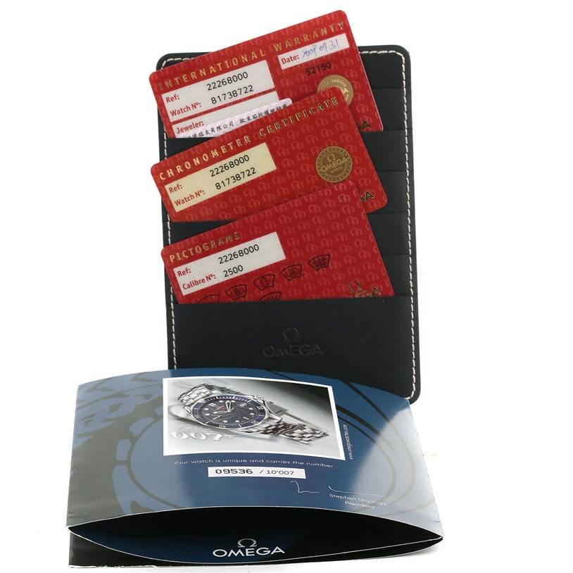 The image shows Omega Seamaster 2226.80.00 Men
s Stainless Steel Blue Dial 2226.80.00 Men
s Stainless Steel Blue Dial model warranty cards, certificates, and a user manual from a top-down angle.