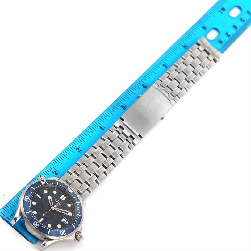 The image shows an Omega Seamaster 2226.80.00 Men
s Stainless Steel Blue Dial 2226.80.00 Men
s Stainless Steel Blue Dial watch laid flat on a ruler with the face, bezel, and full metal bracelet visible.