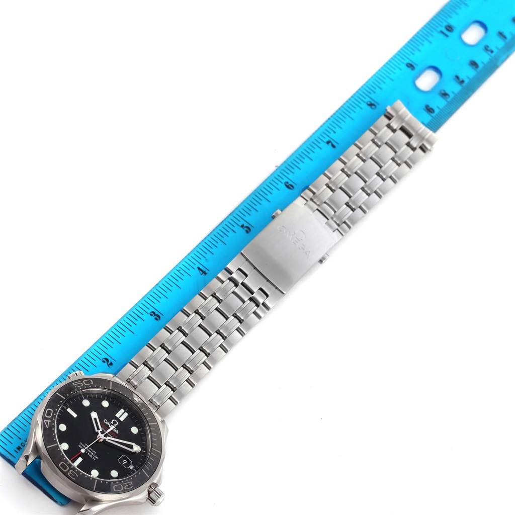 The image shows an Omega Seamaster 212.30.41.20.01.003 Men
s Stainless Steel Black Dial 212.30.41.20.01.003 Men
s Stainless Steel Black Dial watch laid flat next to a ruler, highlighting the watch face and metal bracelet.