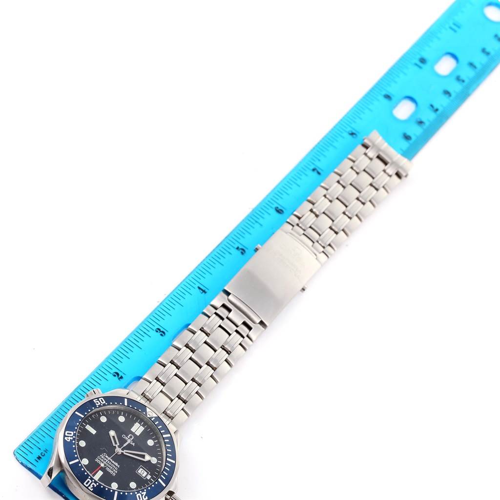 The image shows the Omega Seamaster 2531.80.00 Men
s Stainless Steel Blue Dial 2531.80.00 Men
s Stainless Steel Blue Dial watch laid flat next to a blue ruler, with the watch face, bracelet, and clasp visible.