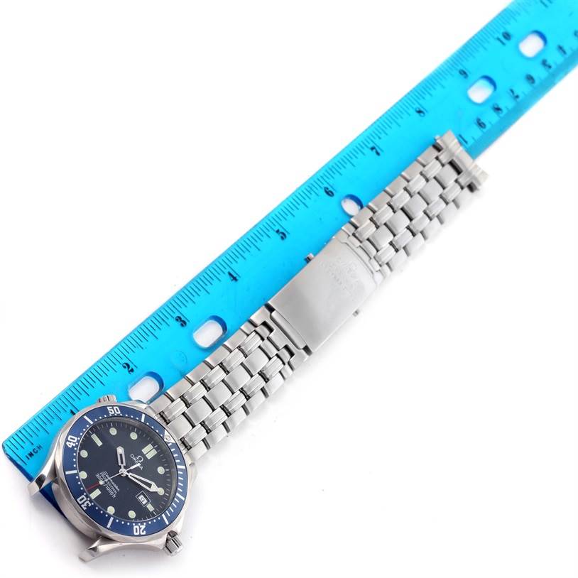 The image shows an Omega Seamaster 2541.80.00 Men
s Stainless Steel Blue Dial 2541.80.00 Men
s Stainless Steel Blue Dial watch laid flat with a blue measurement ruler beside it.