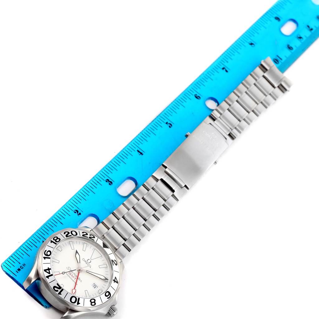 The image shows a top view of an Omega Seamaster 2538.20.00 Men
s Stainless Steel White Dial 2538.20.00 Men
s Stainless Steel White Dial watch, highlighting its bracelet and bezel, measured against a blue ruler.