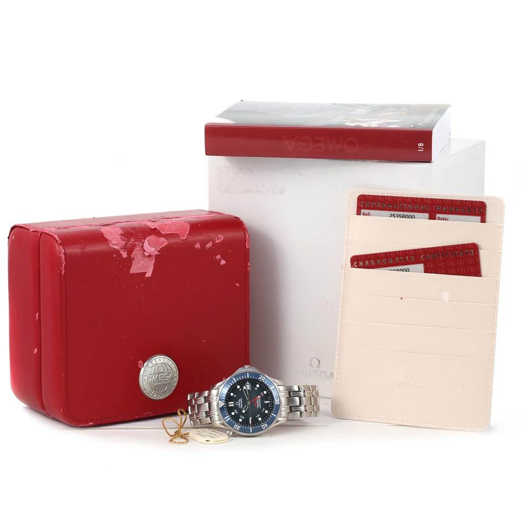 This image shows an Omega Seamaster 2535.80.00 Men
s Stainless Steel Blue Dial 2535.80.00 Men
s Stainless Steel Blue Dial watch, its red case, warranty cards, and a user manual, all viewed from the front.