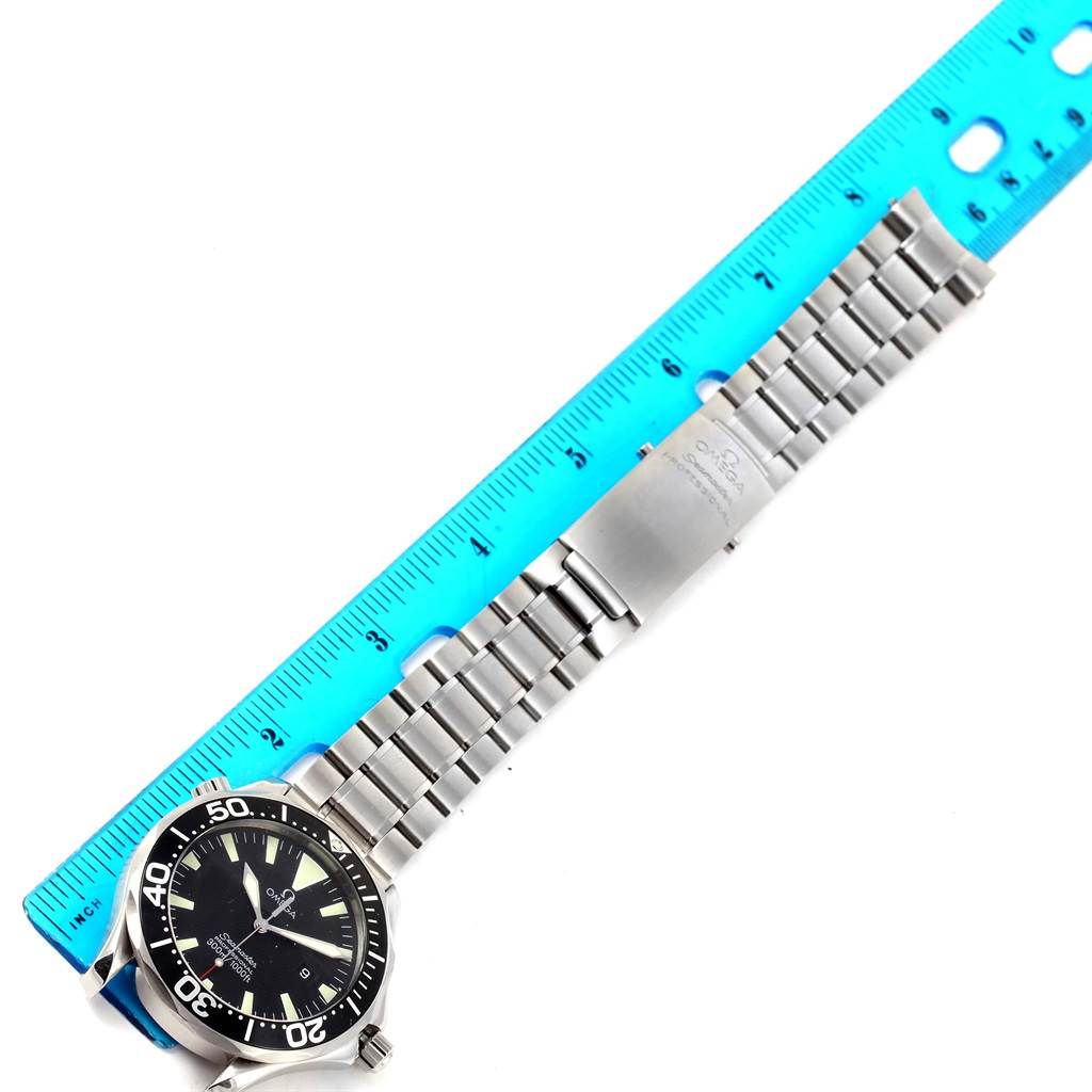 The Omega Seamaster 2264.50.00 Men
s Stainless Steel Black Dial 2264.50.00 Men
s Stainless Steel Black Dial watch is shown from the top view, highlighting its face, bezel, and metal bracelet alongside a blue ruler.